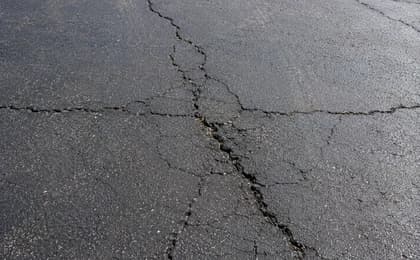 Close customer-style photo of cracked asphalt