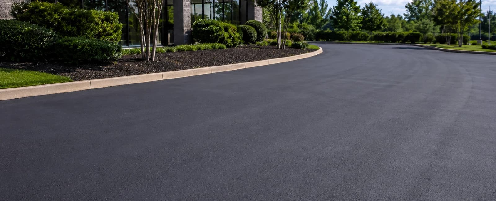 Commercial asphalt lot with a dark refreshed surface