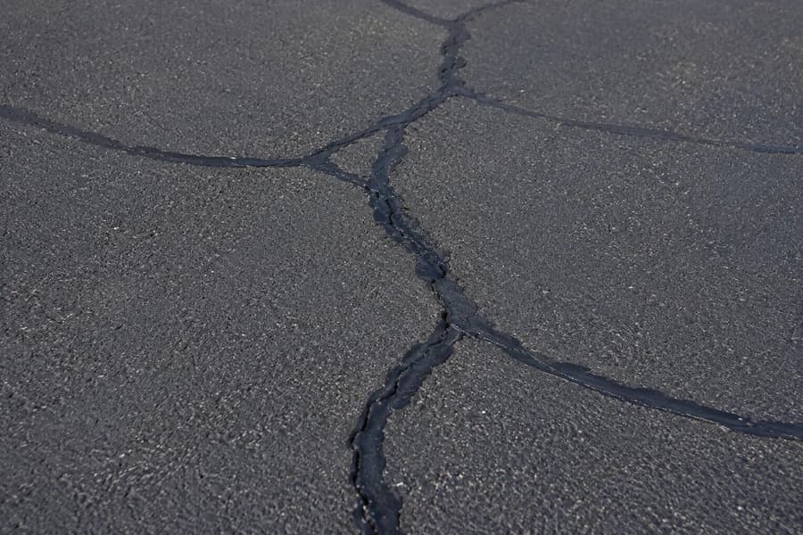 Asphalt cracks sealed with black crack filler